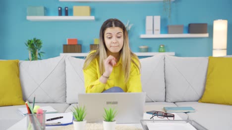 Young-business-woman-surprised-by-what-she-sees-on-laptop.